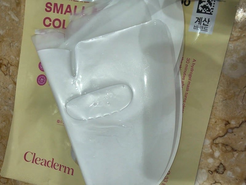 Unfolded Cleaderm hydrogel mask resting on its packet