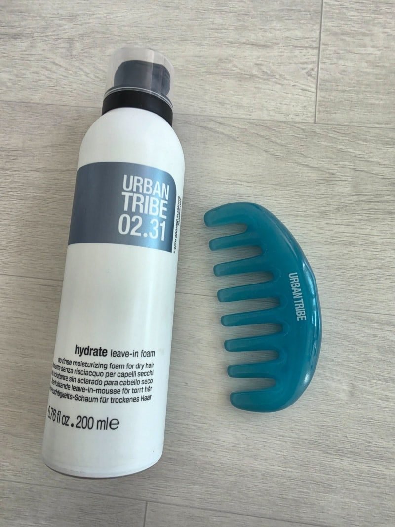 Urban Tribe 02.31 200 ml bottle beside the blue wide-tooth comb