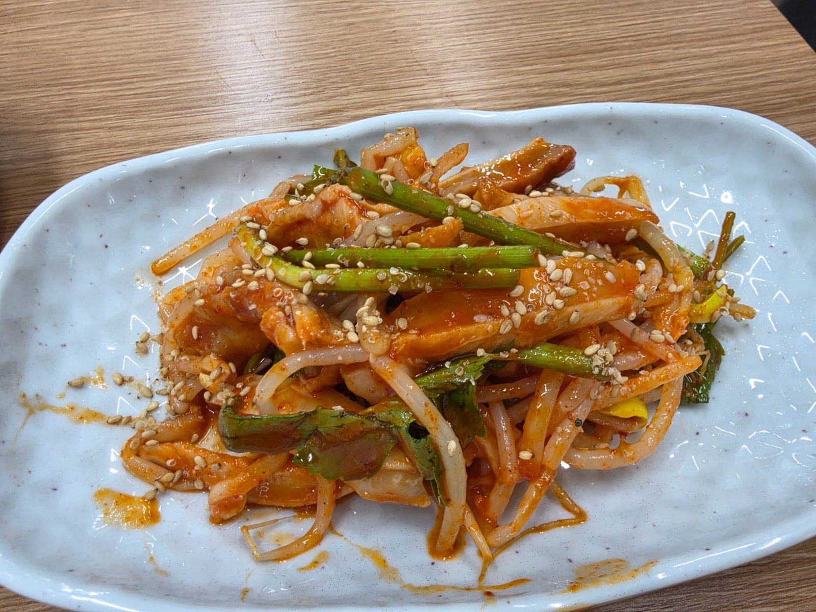 Monkfish stomach salad in red seasoning with bean sprouts and green chilli