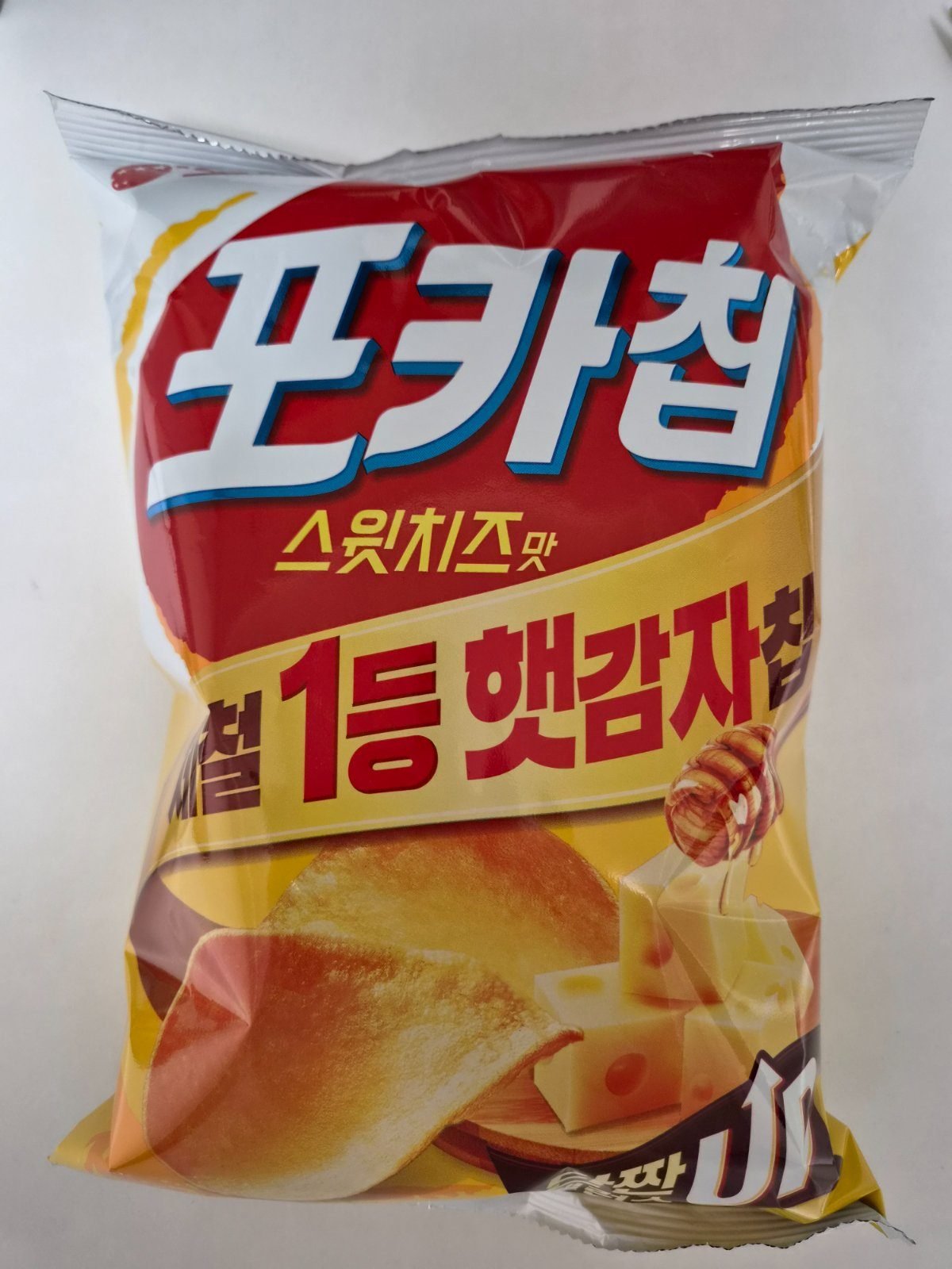 A red and yellow bag of Orion Pocachip Sweet Cheese, a Korean fresh-potato chip