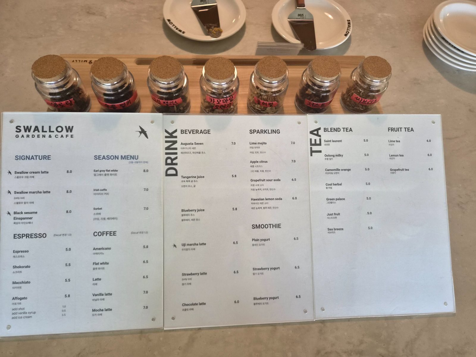 Swallow cafe menu board printed in English with Korean underneath and prices in thousands of won