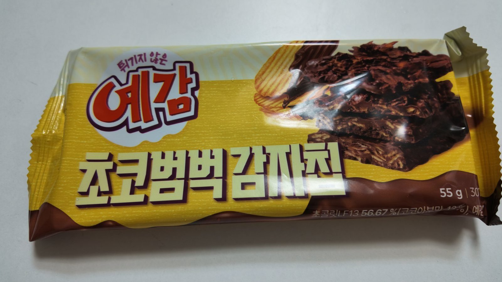 The front and back of a 55 gram Yegam Choco Beombeok chocolate-coated potato chip bar